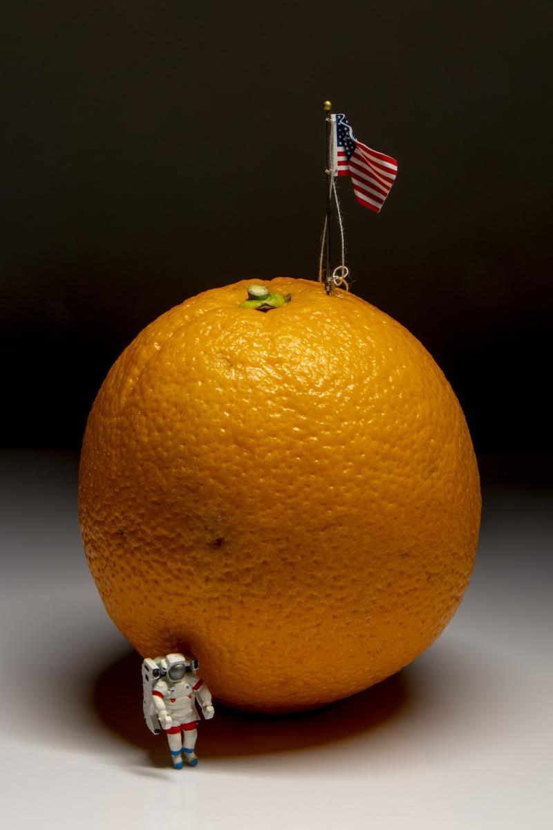Photo of astronaut and American flag on an orange 