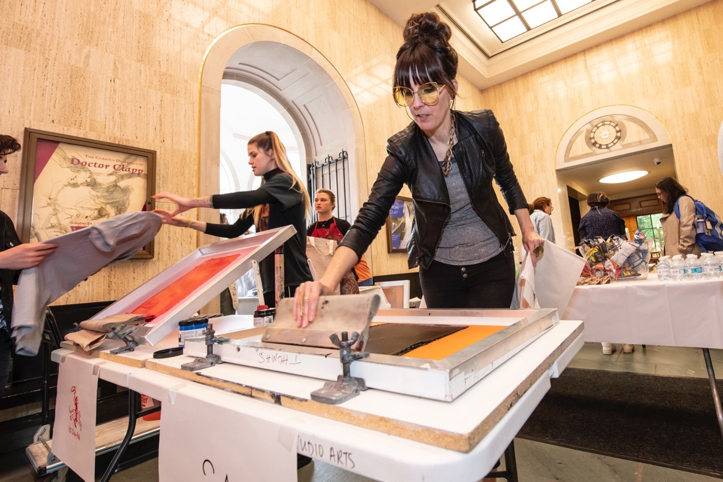 Lenore Thomas leading a screenprinting demonstration in the Lobby of Frick Fine ARts
