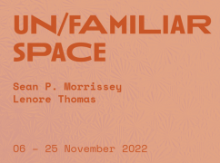 Text that says "Un/Familiar Space" on salmon pink background