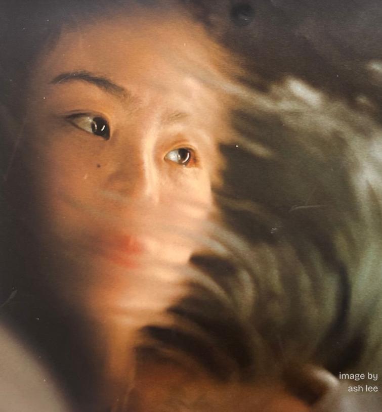 color image of a face swirling into an ambiguous fog