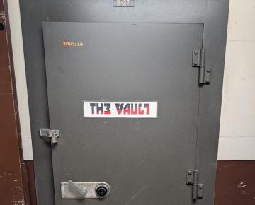 Vault door with a sticker that reads: The Vault