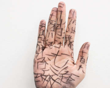 Black ink drawings on the palm of a hand